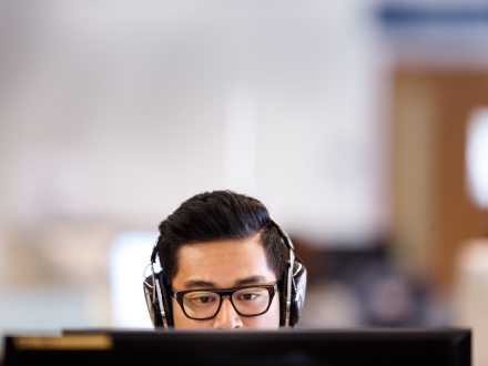 student behind laptop